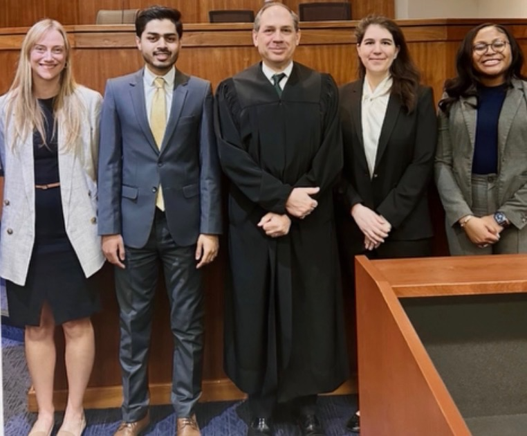 Moaaz Waheed receiving Best Student Advocate Award at the James L. Watson Moot Court